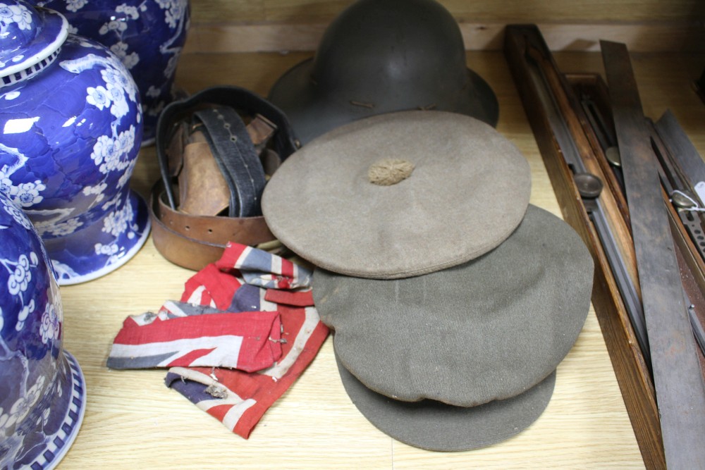 A WWII steel helmet, a Royal Gloucestershire Hussars cap, a Scots Guards? cap, three leather items and a Union Jack